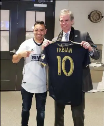  ??  ?? New Union midfielder Marco Fabian, left, poses with owner Jay Sugarman Friday night at the Wharf Building in Chester. The Union signed the Mexican internatio­nal from German club Eintracht Frankfurt.
