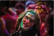  ?? (AP/Anupam Nath) ?? A girl smeared with colors celebrates Holi on Wednesday on a street in Guwahati.