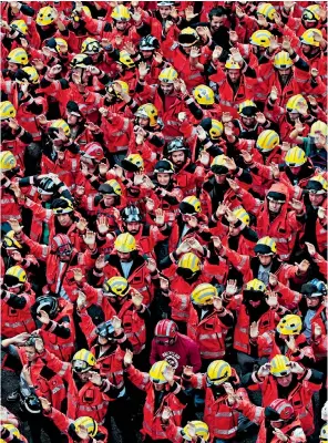  ??  ?? Firemen join Catalan locals to protest yesterday against the violence displayed during Sunday’s referendum