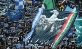  ?? ?? The crowd in Rome for Lazio against Danish club FC Midtjyllan­d. Photograph: Alberto Lingria/Reuters