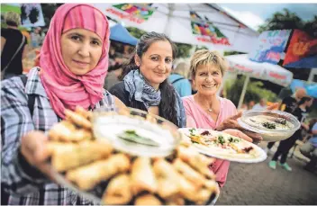  ?? FOTO: RALPH MATZERATH ?? Beim Haaner Sommer reichten Naseera Mohammadi, Hilna Hamo und Ute Hollweg internatio­nalen Speisen.