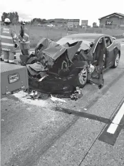  ?? Associated Press ?? ■ This Friday photo released by the South Jordan Police Department shows a traffic collision involving a Tesla Model S sedan with a Fire Department mechanic truck stopped at a red light in South Jordan, Utah. Witnesses indicated the Tesla Model S did...