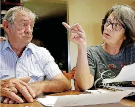  ?? [PHOTOS BY KELLY BOSTIAN/TULSA WORLD] ?? Jerry Linn and Tena Doan talk about the chicken farm next door and go through letters sent to state and local agencies at their dinner table Monday.