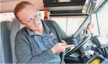  ?? Jason Fochtman/Staff photograph­er ?? Conroe ISD bus driver Lisa Martinez uses the SMART tag system for CISD bus riders.