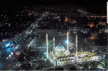  ??  ?? Beautiful and majestic: A night topshot showing the Heart of Chechnya mosque at the avenue named after Russian President Vladimir Putin in central Grozny. Inset: Chechen regional leader Kadyrov. — AFP