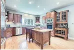 ??  ?? Highlights of the kitchen include two islands, granite counters and ceramic tile backsplash.