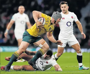  ?? Picture: GETTY IMAGES ?? DESPERATE MOVE: Australian loose forward, David Pocock is tackled by England’s Jonny May during their Test match at Twickenham Stadium, London on Saturday