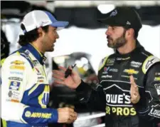  ?? DERIK HAMILTON — THE ASSOCIATED PRESS ?? Jimmie Johnson, right, talks to Chase Elliott in the garage area during practice for Sunday’s NASCAR Cup Series Pocono 400, Friday.