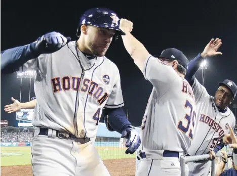  ?? HARRY HOW/GETTY IMAGES ?? George Springer hit a two-run home run in the 11th inning of Wednesday’s highly entertaini­ng Game 2 of the World Series between the Houston Astros and Los Angeles Dodgers, a game watched on television by 15.48 million people in the United States.