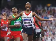  ?? ?? Britain’s Mohamed Farah celebrates Aug. 11, 2012, as he crosses the finish line to win the men’s 5000-meter final during the athletics in the Olympic Stadium at the 2012 Summer Olympics in London.
