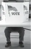  ??  ?? A Republican casts a ballot at the fire hall Tuesday in Flushing, Ohio.