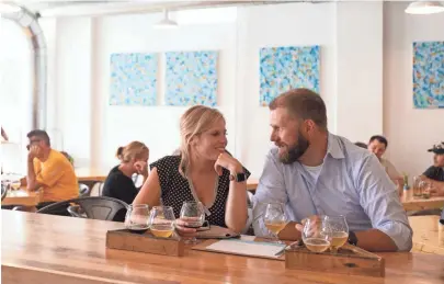  ?? CHRIS KOHLEY / MILWAUKEE JOURNAL SENTINEL ?? Brianne Deja and John Somers share a beer flight on the opening day of Vennture Brew Co., 5519 W. North Ave.