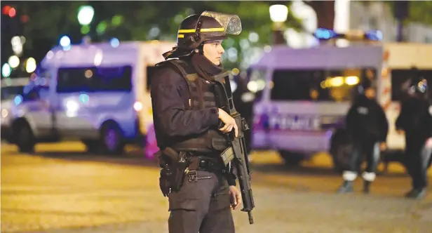  ?? Picture: Getty Images ?? FORCEFUL. Police officers secure the area after a gunman opened fire on the Champs Elysees on Thursday in Paris, France. One officer was killed, and two others injured by a gunman on The Champs Elysees. Security is heightened in Paris with the first...