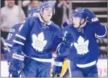  ?? The Canadian Press ?? Toronto Maple Leafs centre Auston Matthews, front, reacts to a goal during third-period NHL action against the Pittsburgh Penguins in Toronto on Saturday. The Leafs won 5-3.