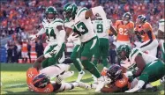  ?? David Zalubowski / Associated Press ?? Jets linebacker Del'Shawn Phillips (43) runs a fumble recovery against the Broncos during the second half on Sunday in Denver.