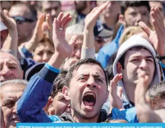  ??  ?? YEREVAN: Armenian people shout during an opposition rally in central Yerevan yesterday, as parliament elected the country’s ex-president as prime minister under a new parliament­ary system of government. — AFP