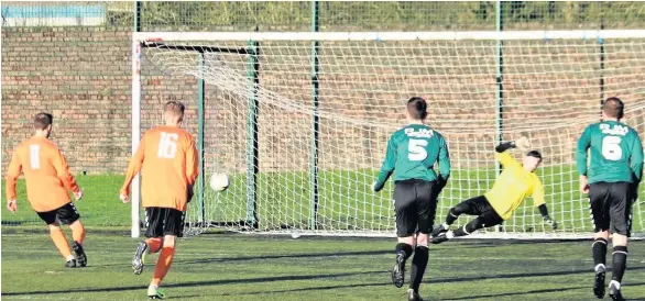  ??  ?? Wrong way Lukasz Duszynski (11) puts Doune 5-2 up from the penalty spot