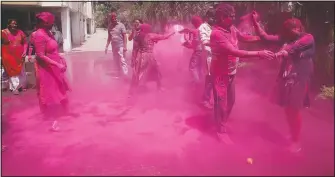  ?? (AP/Rajesh Kumar Singh) ?? Indian throw color during celebratio­ns to mark Holi in Prayagraj, India.