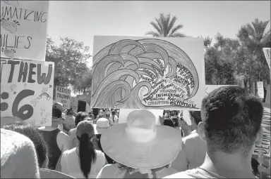  ?? MELISSA DANIELS / ASSOCIATED PRESS ?? Protesters rally June 30 at a Keep Families Together march in Phoenix.