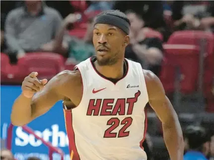  ?? MARTA LAVANDIER/AP ?? Heat forward Jimmy Butler gestures after scoring during the second half Wednesday against the Kings in Miami.