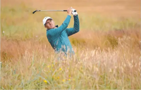  ??  ?? FIELD OF DREAMS: Defending champion Jordan Spieth familiaris­es himself with the rough at Carnoustie. Pictures: GETTY IMAGES