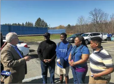  ?? PHOTOS BY LINDSAY MORAN — FOR THE RECORD ?? Tim Riley, left, marketing and communicat­ions director for the Northeaste­rn New York chapter of the Make-A-Wish Foundation, surprises Columbia High School student Cameron Newman, center, standing with his family, on Friday morning with news that he...