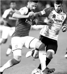  ??  ?? Arsenal’s player Olivier Giroud (L) fights for the ball with Western Sydney’s Brendan Hamill during a friendly match in Sydney on July 15, 2017.- AFP photo