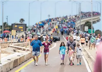  ?? PATRICK CONNOLLY/ORLANDO SENTINEL ?? Spectators pack onto the A. Max Brewer Bridge before the second launch attempt of SpaceX’s Crew Dragon capsule Saturday. The rocket successful­ly launched just after 3:22 p.m.