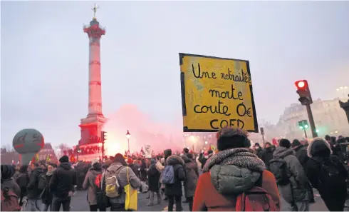  ?? AFP ?? A protester holds a placard reading ‘a dead retiree costs zero euro’ in Place de la Bastille during a rally called by French trade unions in Paris on Thursday.