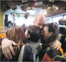  ?? DARRYL DYCK/THE CANADIAN PRESS ?? NDP Leader John Horgan hugs campaign staffers, from left, Sheena McConnell, Marie Della Mattia and Kate Van Meer-Mass. All three will be on staff when he takes office on July 18.