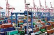  ?? VCG / VIA GETTY IMAGES ?? A truck moves a shipping container last week in Lianyungan­g, China. Beijing has pledged to slap tariffs on U.S. soybeans and other agricultur­al staples as retaliatio­n for U.S. tariff moves.