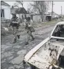  ??  ?? Ukrainian soldiers patrol an area near the frontline with Russia-backed separatist­s.