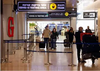  ?? ?? Travellers exit the COVID pandemic testing area at Ben Gurion Internatio­nal Airport. AMIR COHEN/REUTERS