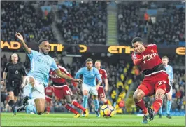  ??  ?? Watford's Etienne Capoue (R) has a shot at goal foiled by Manchester City's Raheem Sterling during their match at the Etihad Stadium in Manchester.