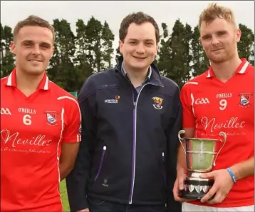  ??  ?? Fethard joint captains Graham O’Grady and Kevin Rowe after receiving the cup from C athal Byrne, Developmen­t Officer of the County Board.