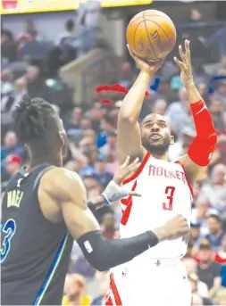  ??  ?? Chris Paul (No. 3) of the Houston Rockets takes a shot against Nerlens Noel of the Dallas Mavericks at American Airlines Center in Dallas, Texas. REIGNING champion San Miguel Beer shoots for a commanding 3- 0 advantage against Barangay Ginebra San...