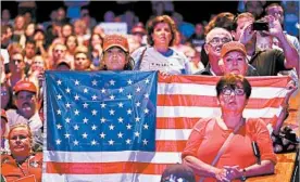 ?? JOE RAEDLE/GETTY ?? GOP presidenti­al nominee Donald Trump supporters listen intently last week in Miami. The nation will pay rapt attention Monday as Trump and Hillary Clinton meet in a debate.