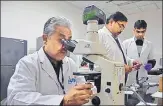 ?? HT ?? Dr PS Banerjee (looking into a microscope) and his team from the Indian Veterinary Research Institute helped identify the infection that the woman had caught during a visit to Africa.