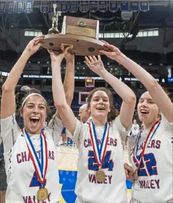  ?? Steph Chambers/Post-Gazette ?? Chartiers Valley's Megan McConnell, Aislin Malcolm and Amaleen Malcolm hold up the championsh­ip trophy after defeating Trinity, 58-40, for the WPIAL Class 5A title.