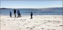  ?? Joe Amarante / Hearst Connecticu­t Media file photo ?? A family strolls along the beach at Rocky Neck State Park in East Lyme.