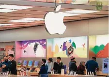  ?? Gene J. Puskar/Associated Press ?? Customers shop at an Apple store Tuesday in Pittsburgh. A new report says Apple and Google app stores stifle competitio­n.