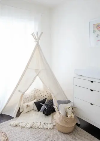  ??  ?? Oh, Baby Baby Roen’s Stokke Roof bed is filled with cozy cushions, as is the little white teepee-style tent set up in the corner; prints picked up on a trip to Australia add a little colour to the clean white walls. The white minimalist dresser and...