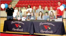  ?? MARK HUMPHREY/ENTERPRISE-LEADER ?? Kaylynn Bates, a 2017 Farmington graduate, signed a national letter of intent to play women’s college volleyball for Rockhurst University, of Kansas City, Mo. Monday at Cardinal Arena. Joining her in the celebratio­n were her Lady Cardinal volleyball...