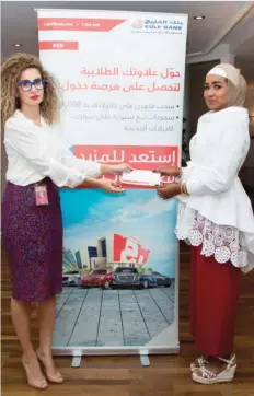  ??  ?? Manal Barakat, Manager, Consumer Banking at Gulf Bank congratula­tes Soad Abdullah Houran Al-Marzook, the 8th winner of the monthly cash draw for the Red Account 2016.