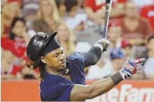  ?? AP PHOTOS ?? FREE SWINGERS: Hanley Ramirez (top) loses his helmet striking out in the fifth inning, but Dustin Pedroia connects for a hit in the seventh inning of the Red Sox’ 6-2 win over the Angels last night.