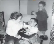  ??  ?? Young Anne with her brothers and her first cat, Boots