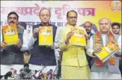  ??  ?? ■ Union minister Arun Jaitley (second from left) and CM Shivraj Singh Chouhan release BJP manifesto in Bhopal, Saturday. MUJEEB FARUQUI/HT