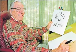 ?? CP PHOTO ?? Cartoonist Charles Schulz displays a sketch of his beloved character Snoopy in his office in Santa Rosa, Calif. in this 1997 photo. The Peanuts gang of cartoon characters created by Schulz is getting a new home at a Halifax-based entertainm­ent company...