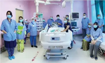  ?? — Photo from Noor Hisham Abdullah’s Facebook page ?? Medical staff are seen with the baby and mother.