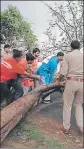  ?? HT PHOTOS ?? An electricit­y pole uprooted during the storm and (right) police officials, along with locals, remove a tree that fell in Mathura, Uttar Pradesh, on Sunday.